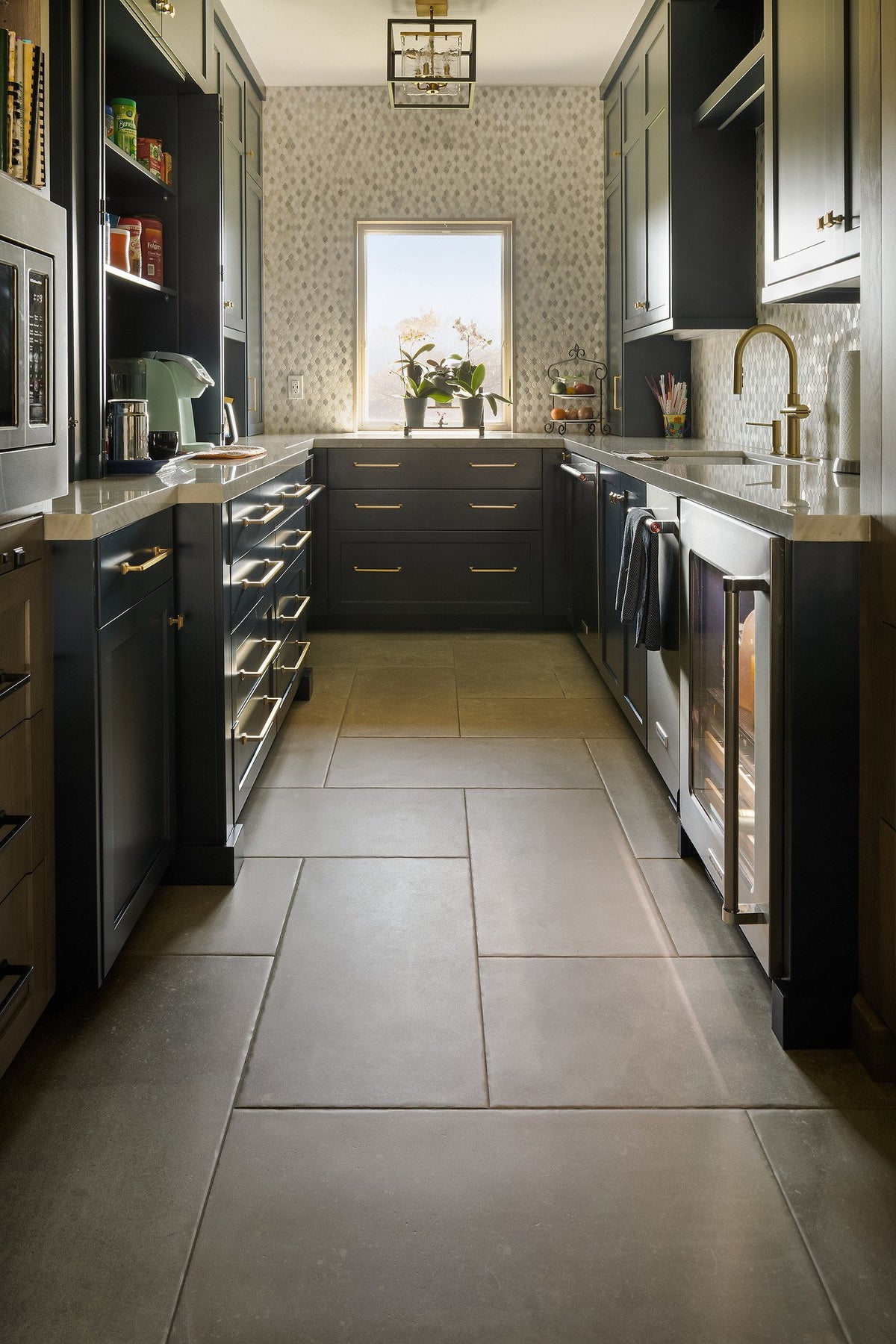 Galley kitchen with dark cabinetry