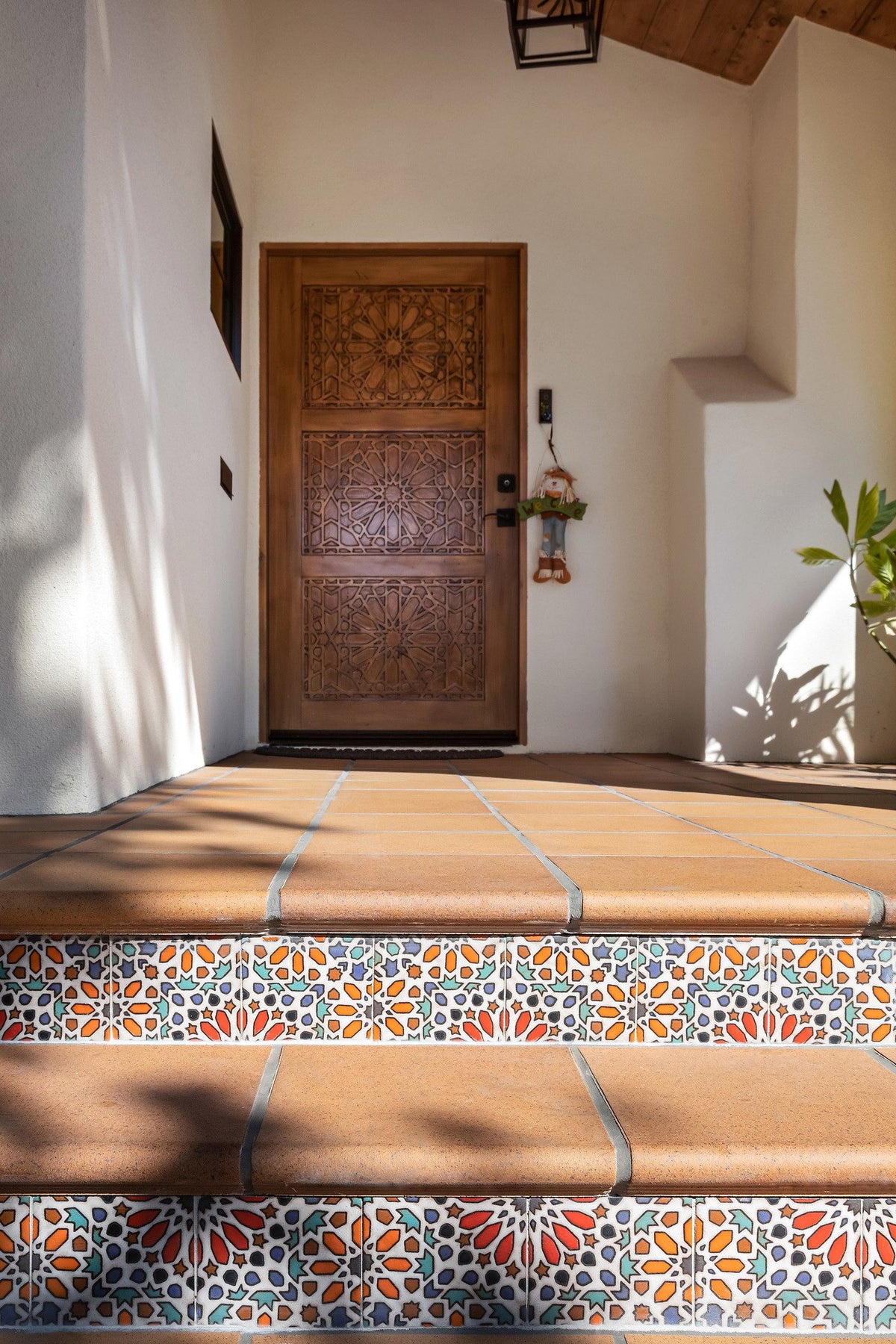 Porch steps leading to carved door