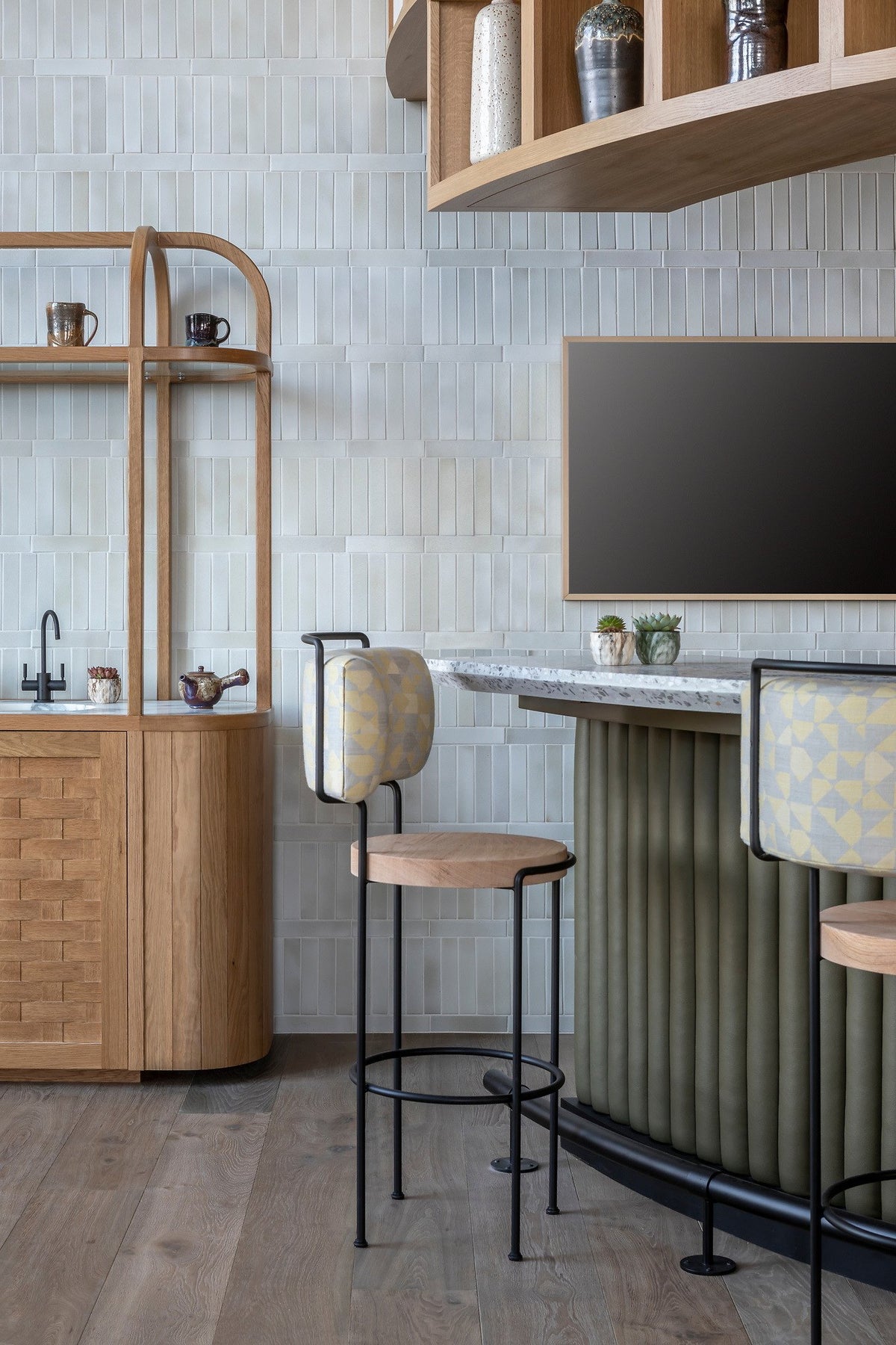Bar stools against the tiled wall