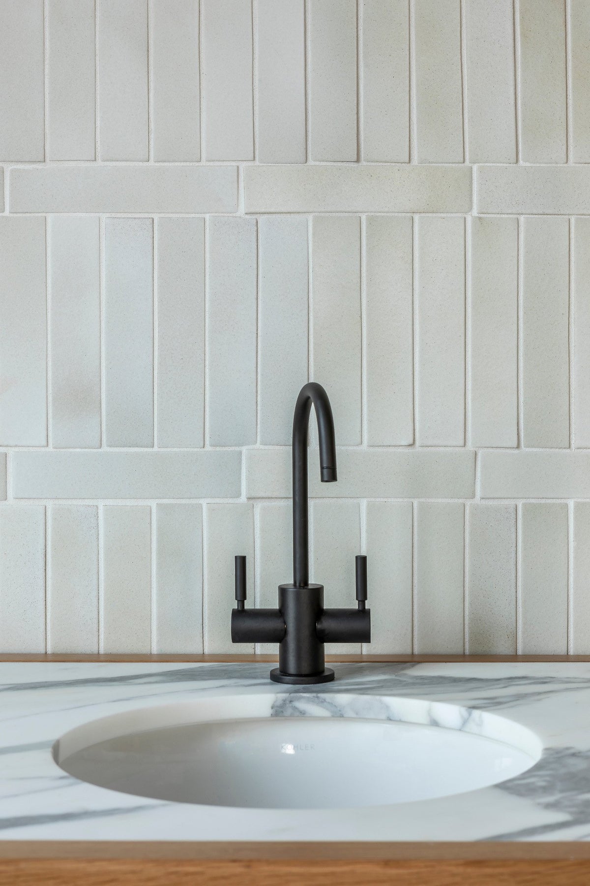 Stacked 2x8 tile above the sink