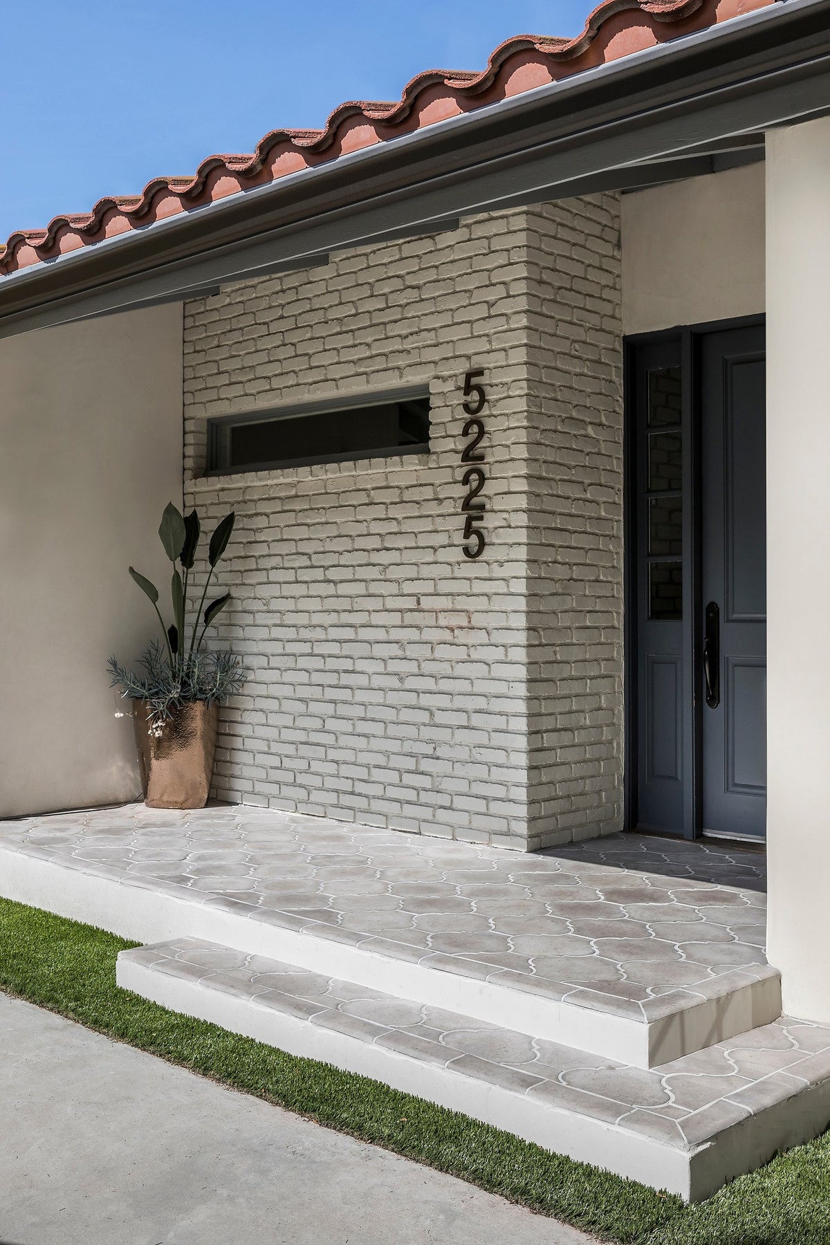 Porch and step beside brick wall